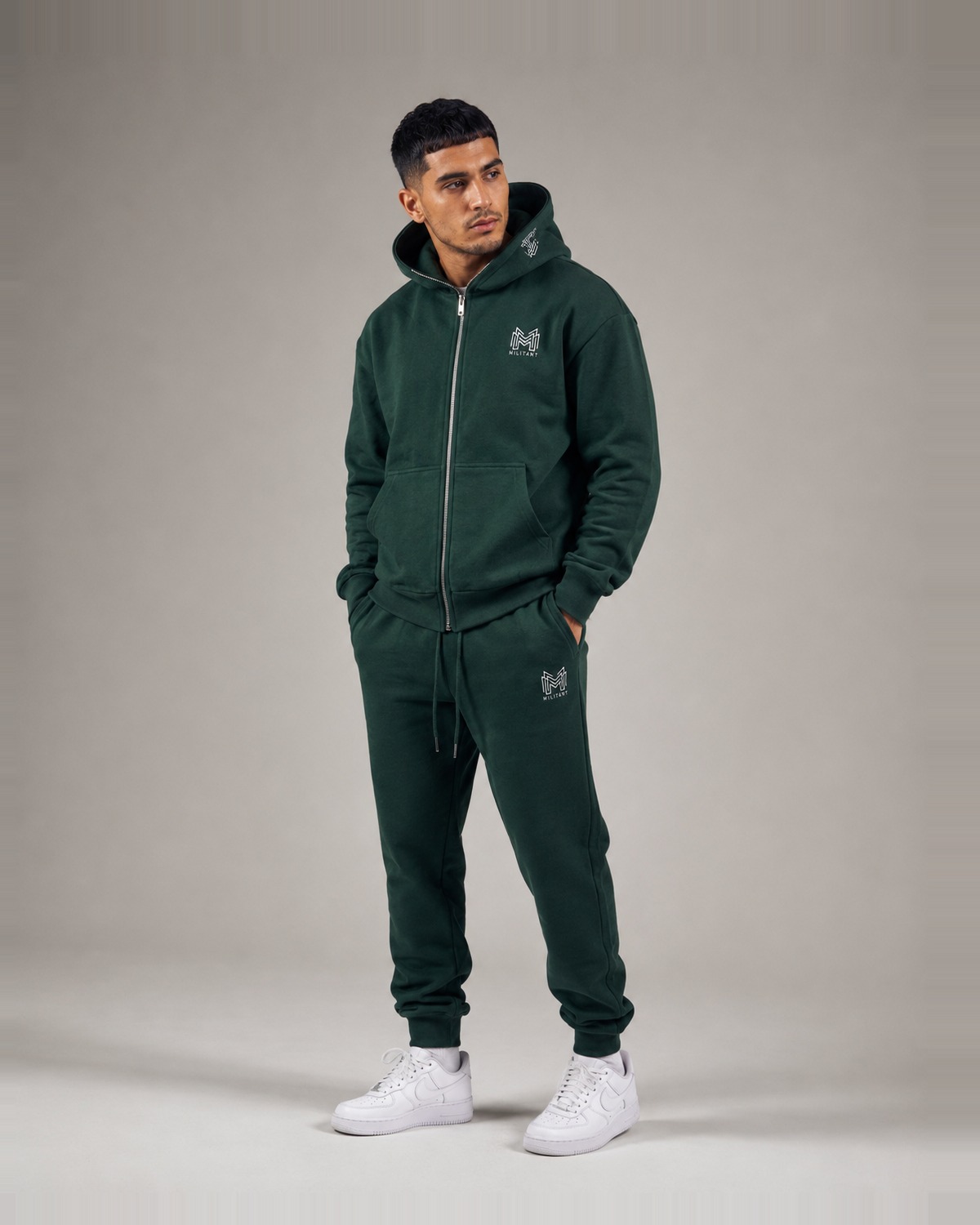 MILITANT hoodie worn with the integrated face cover concealed